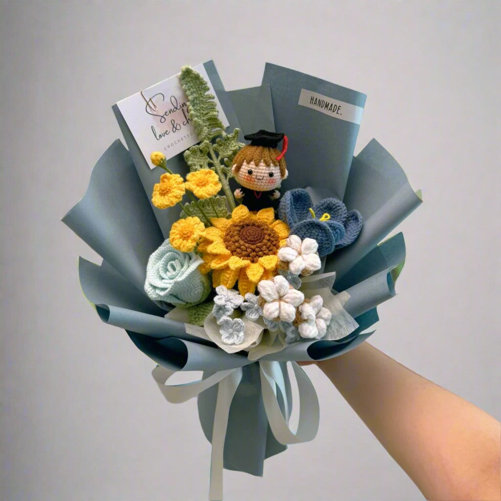 Bouquet with flowers, a small figurine, and books on a plain background