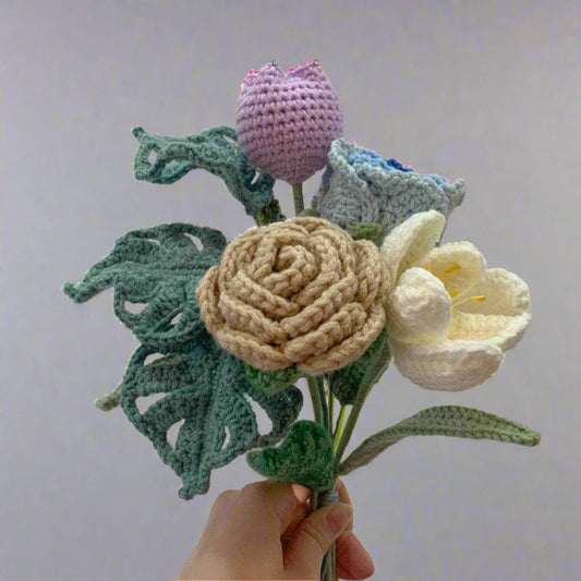 Hand holding a bunch of crochet flowers