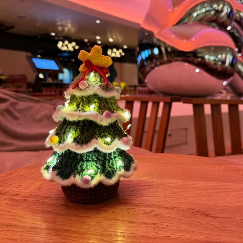 Lighted Crochet Christmas Tree in a dark room setting on a wooden table