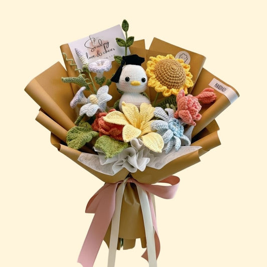 Bouquet of knitted flowers and a small plush toy in brown paper packaging on a beige background