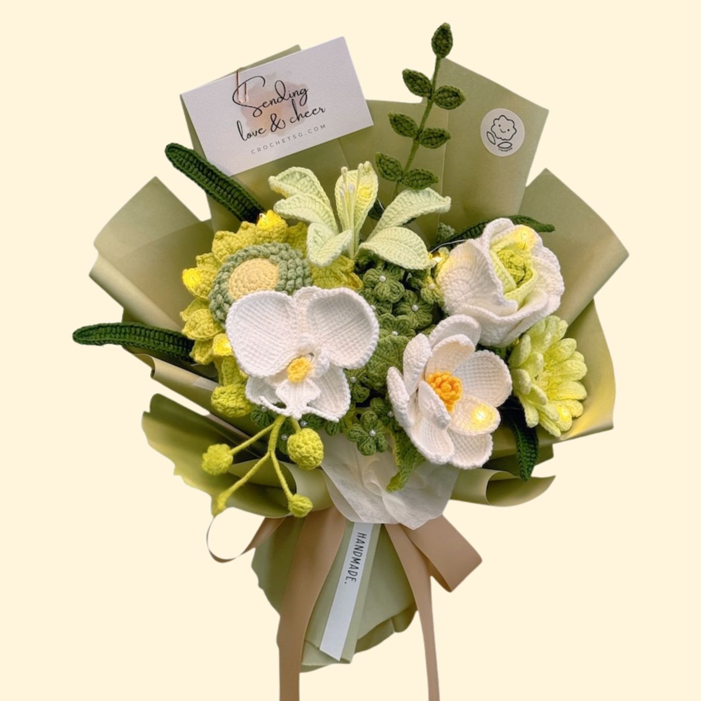 Knitted flower bouquet with green and yellow tones on a beige background
