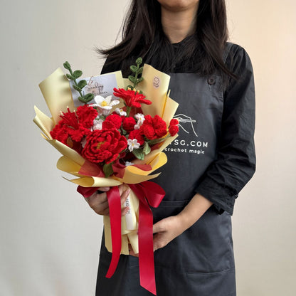 Person holding a bouquet of red flowers with a red ribbon, wearing a black apron with text.