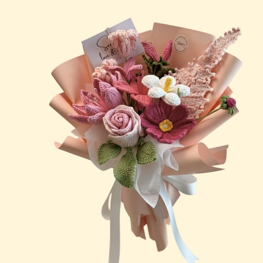 Knitted flower bouquet with ribbons on a beige background