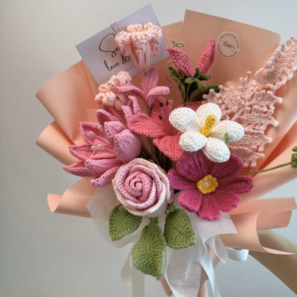 Bouquet of knitted flowers with a card on a light background