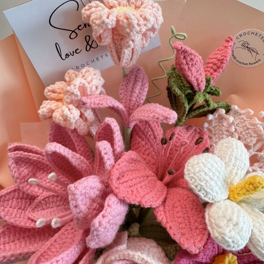 Collection of crocheted flowers with a card in the background