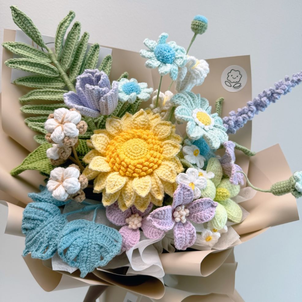 Bouquet of crocheted flowers in various colors on a light background