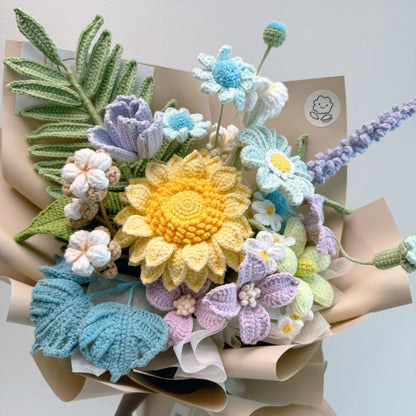Bouquet of crocheted flowers in various colors on a light background