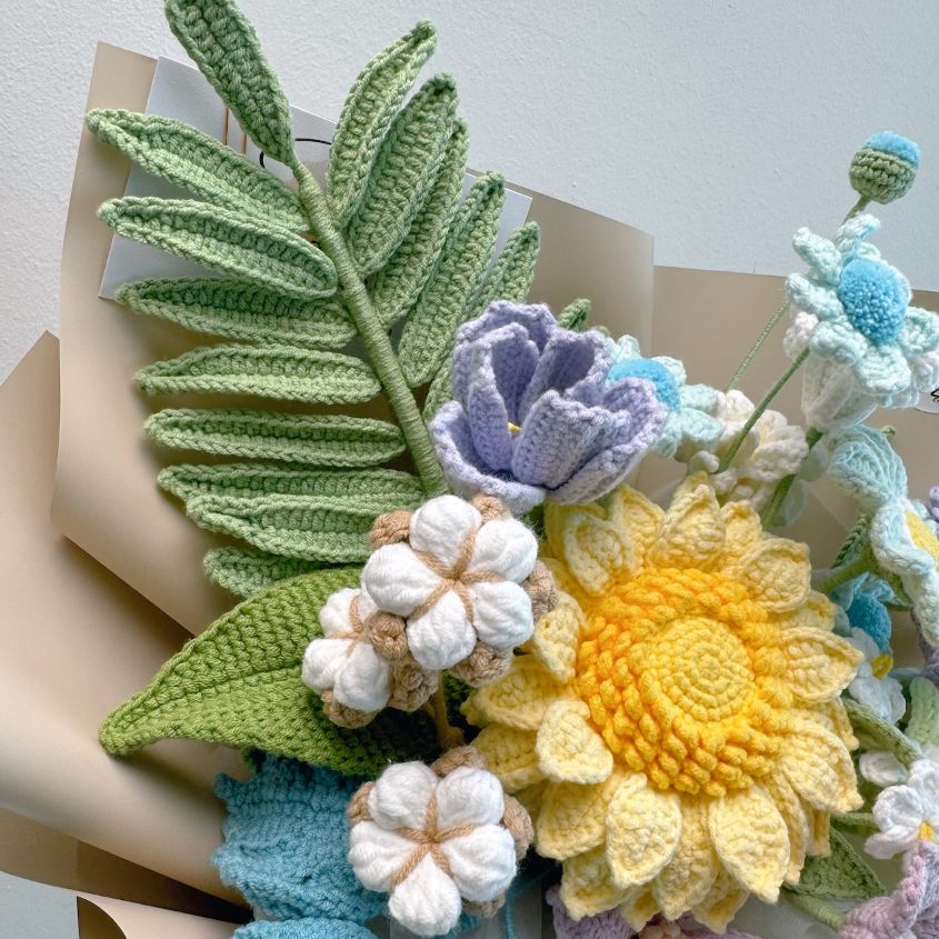 Crocheted flowers and leaves on a neutral background