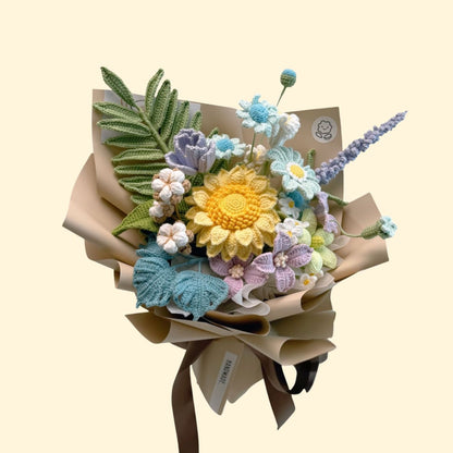 Knitted flower bouquet with a yellow center and green leaves on a beige background