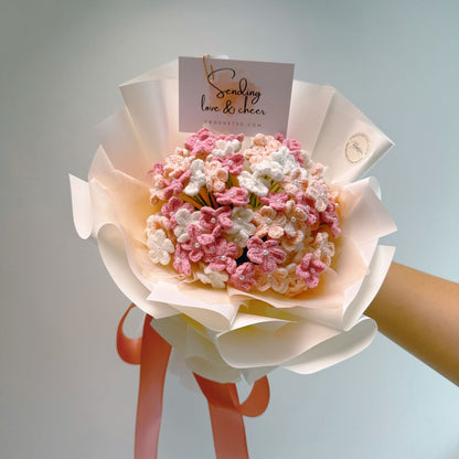 Bouquet of pink and white flowers with a card on a light gray background
