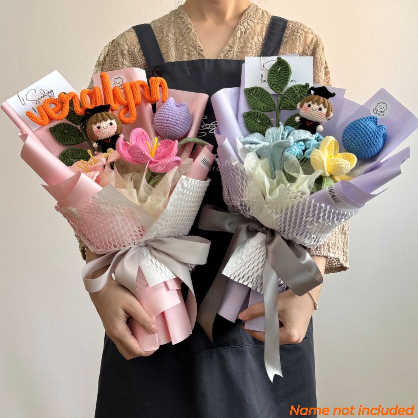 Two bouquets of knitted toys held by a person against a plain background.