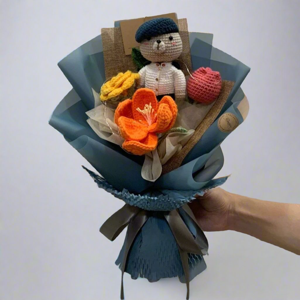 A bouquet with crochet flowers and a customised crochet bear wearing SAF uniform